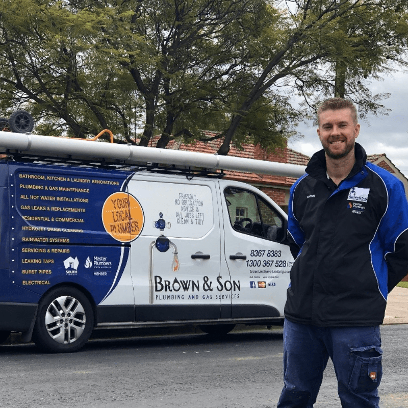 Brown and Son Plumbing business founder, Anton Brown with his work van on a suburban street in Adelaide
